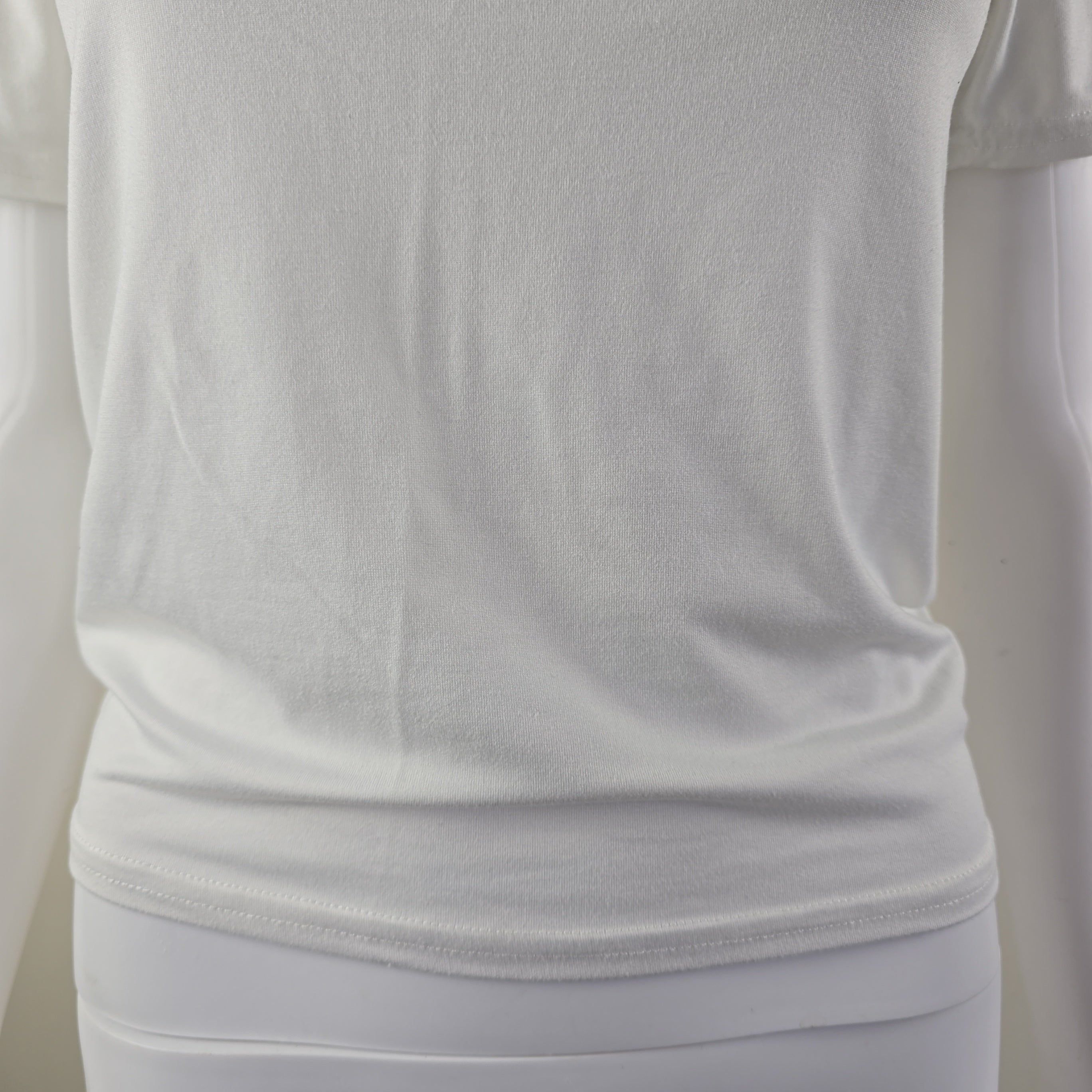 Close-up of a white fabric with folds on a light gray background