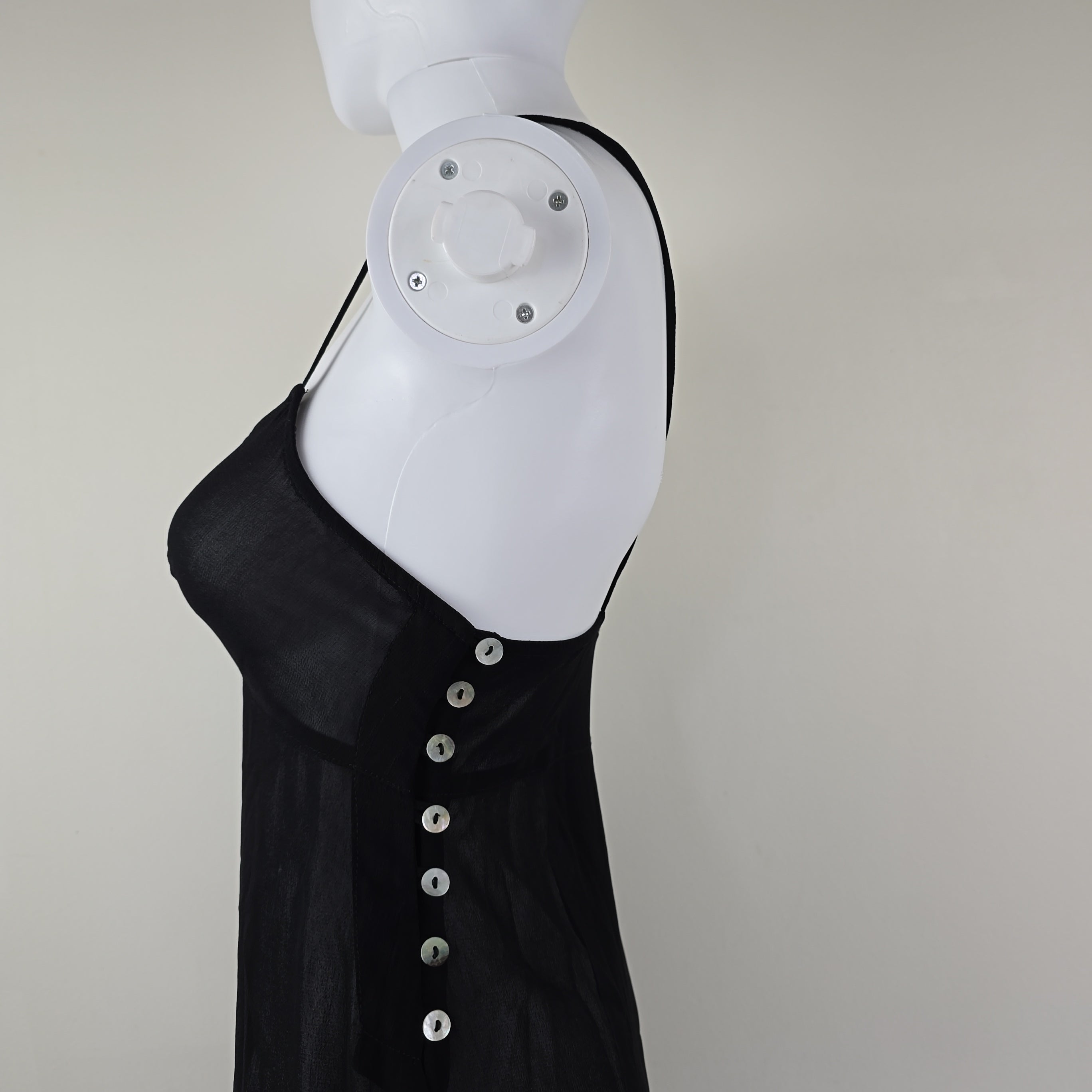 Black dress with beige lining on a light floor