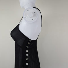 Black dress with beige lining on a light floor