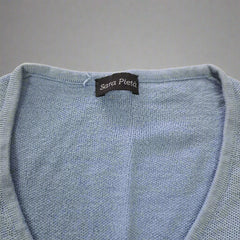 Close-up of a blue textured fabric with a label on a beige background
