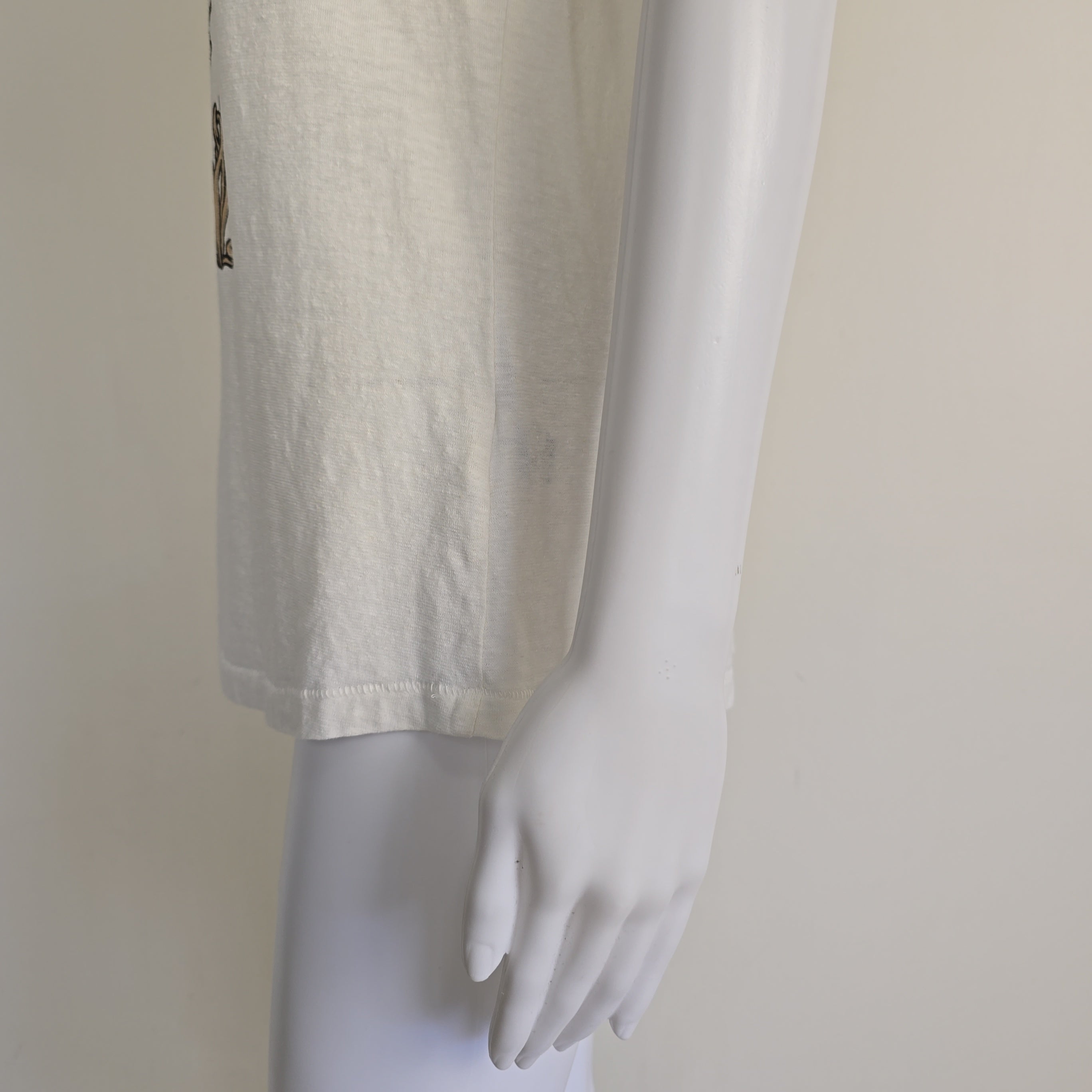 White t-shirt with floral design and text on a light background