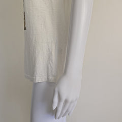 White t-shirt with floral design and text on a light background