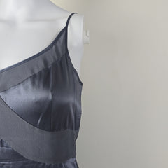 Dark grey satin garment on a mannequin against a plain background