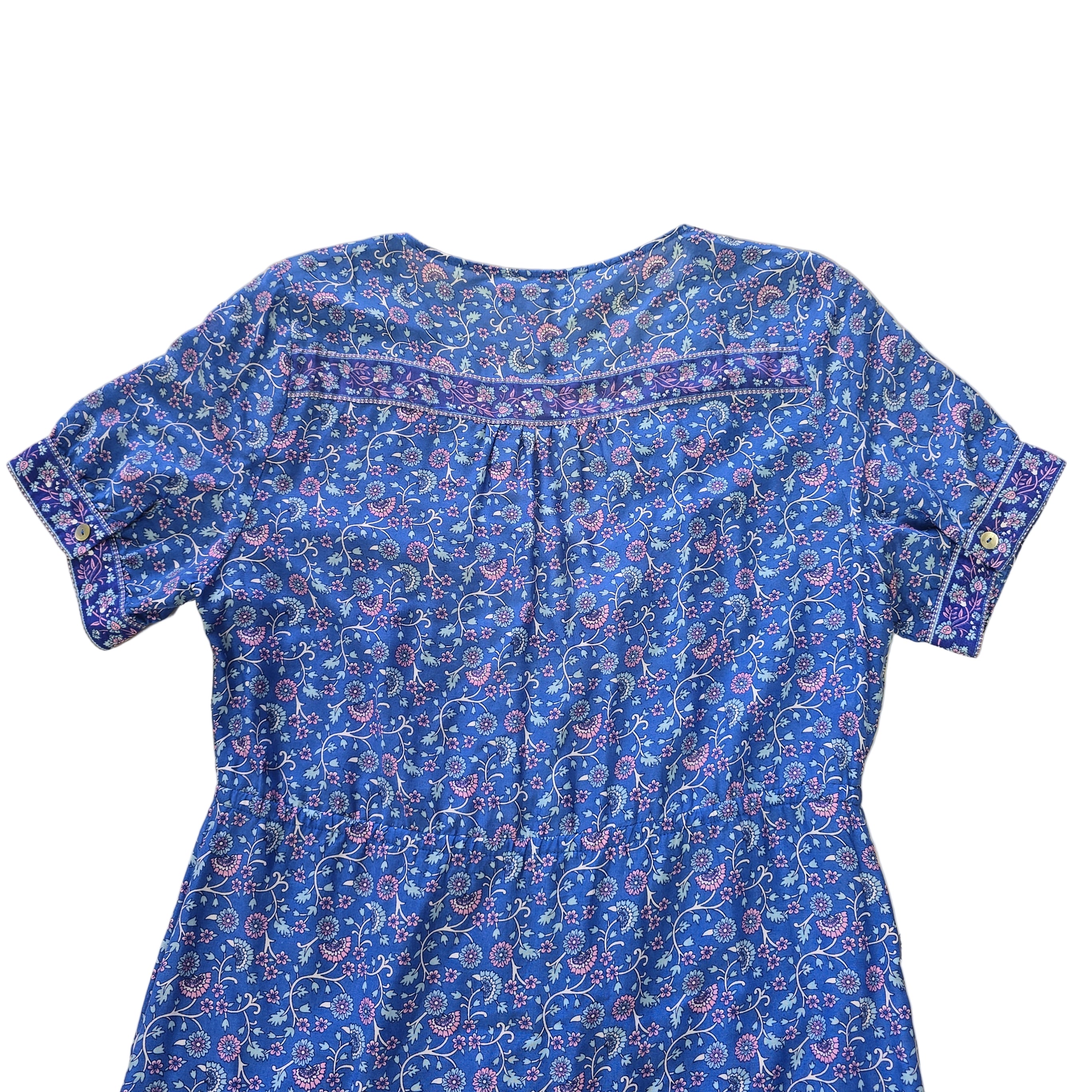 Blue floral-patterned dress on a tiled floor