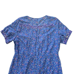 Blue floral-patterned dress on a tiled floor