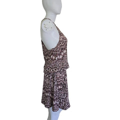 Floral-patterned dress on a mannequin arm against a plain background