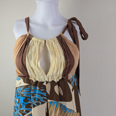Mannequin wearing a brown and beige dress with abstract pattern on a neutral background