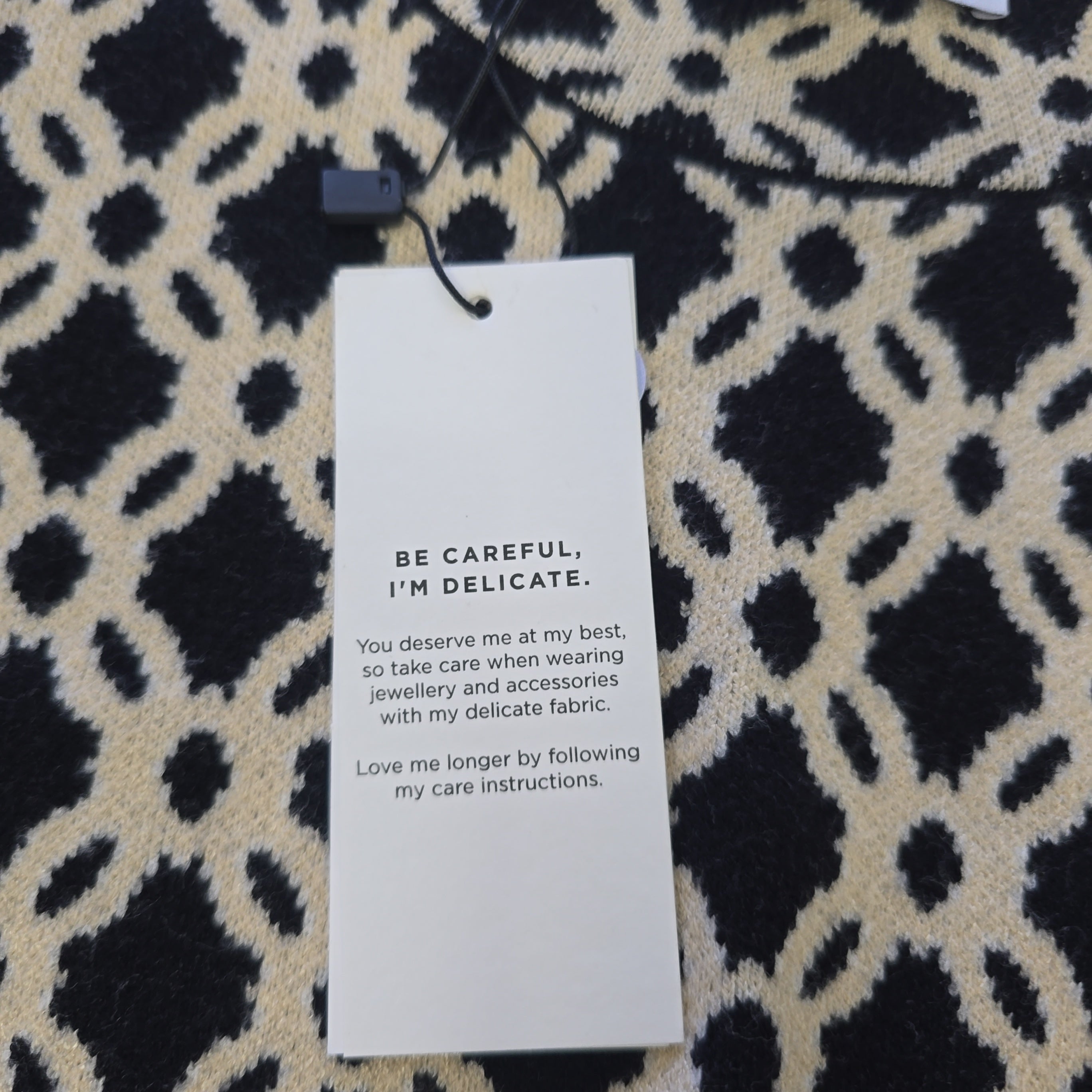 Text tag on a patterned fabric background