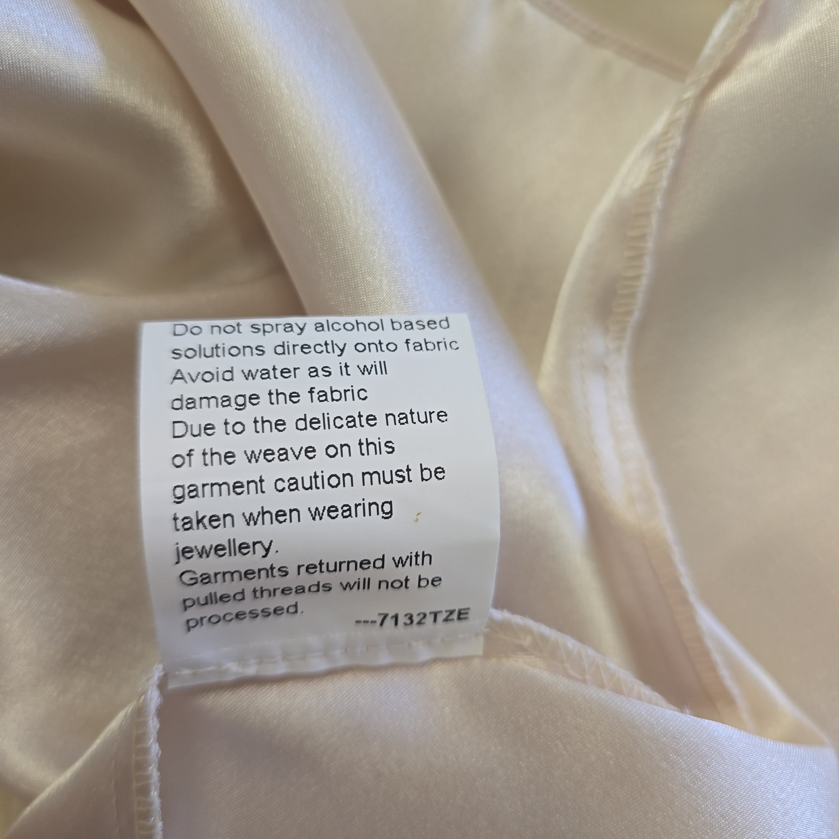 Close-up of a label on beige fabric with text