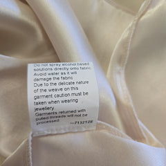 Close-up of a label on beige fabric with text