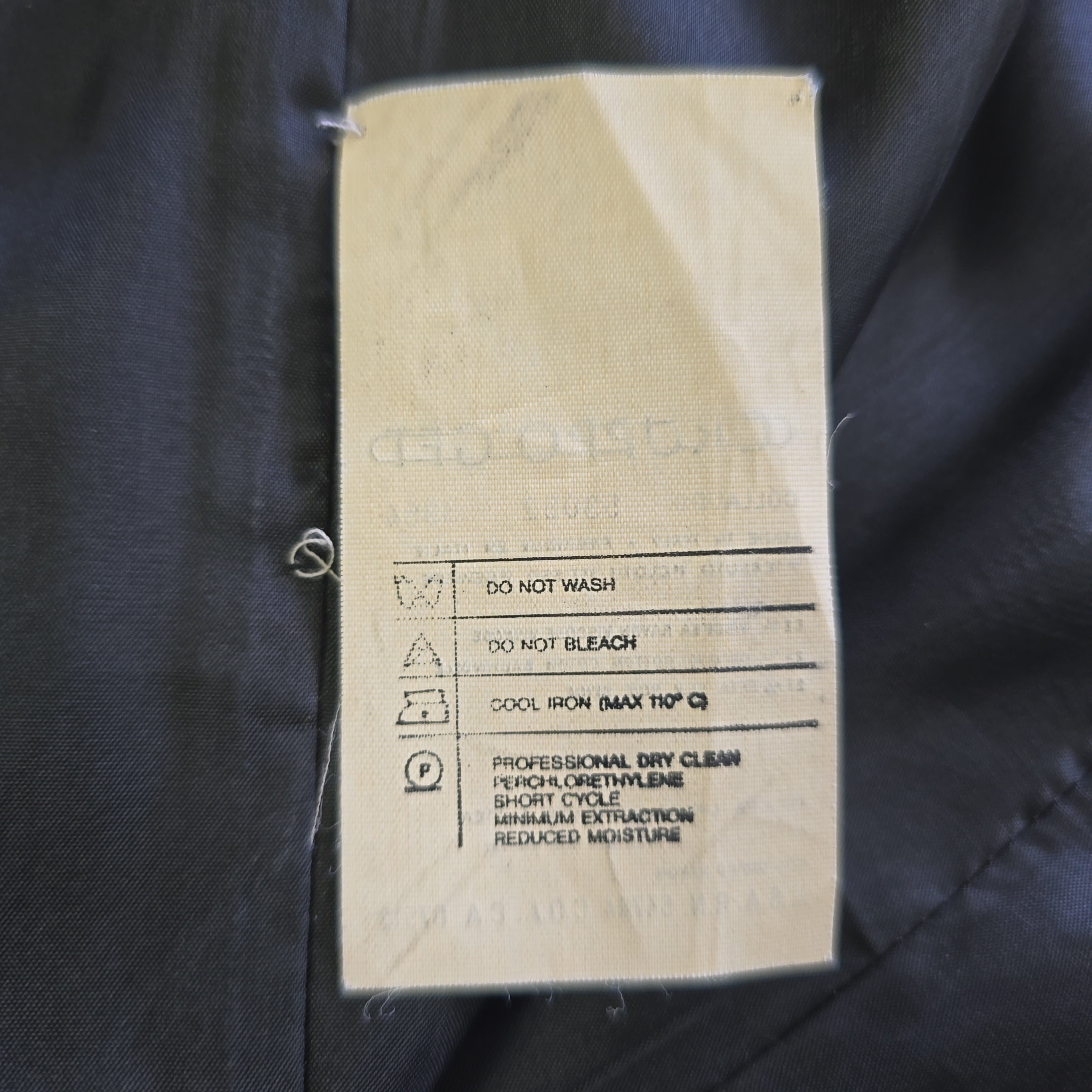 Clothing label on a dark fabric background