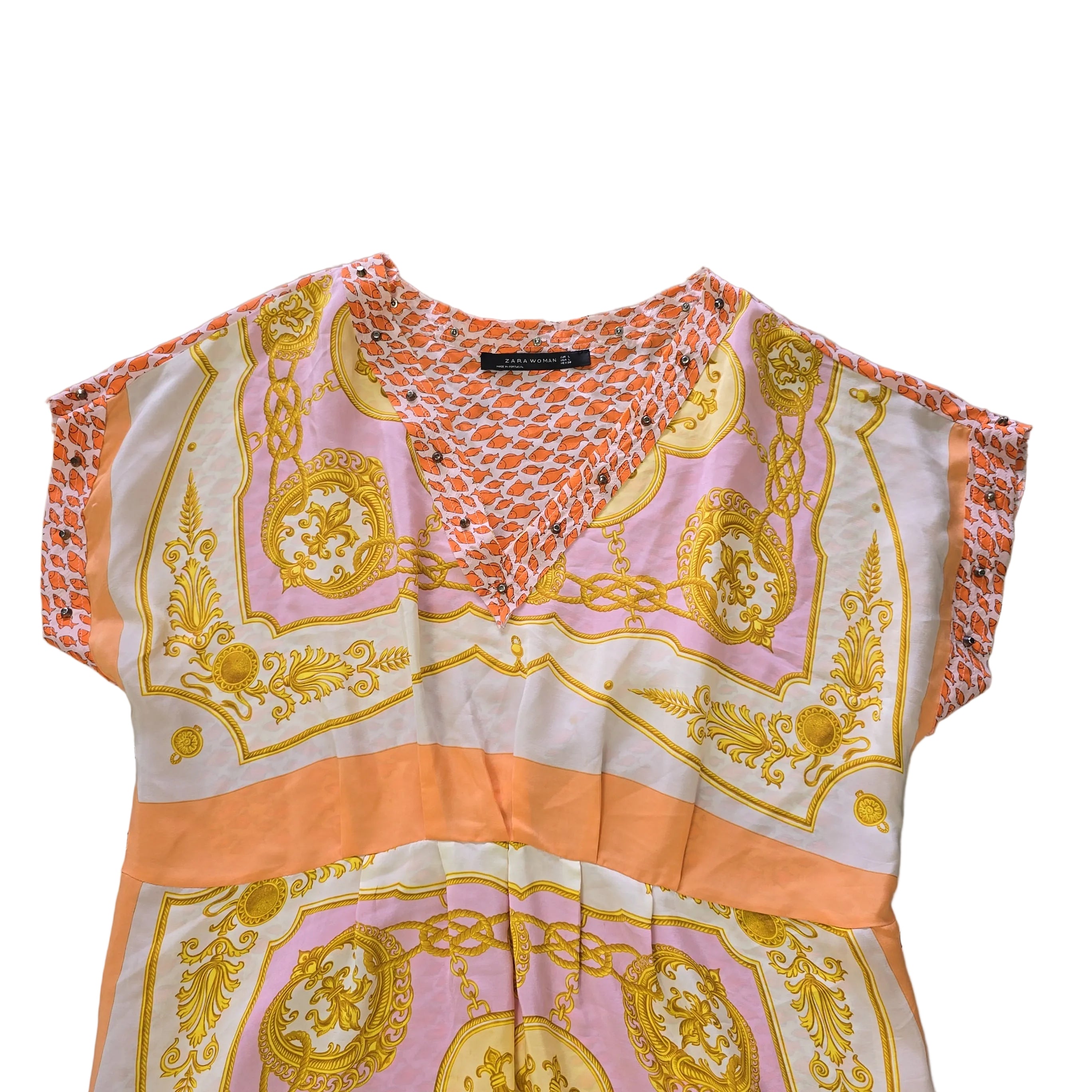 Decorative pink and yellow patterned fabric kaftan on a light background.