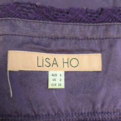Close-up of a purple garment with a 'Lisa Ho' label.