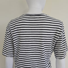 Black and white striped garment on a mannequin against a plain background