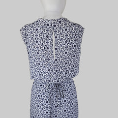 Blue and white patterned strapless top on a mannequin against a beige background