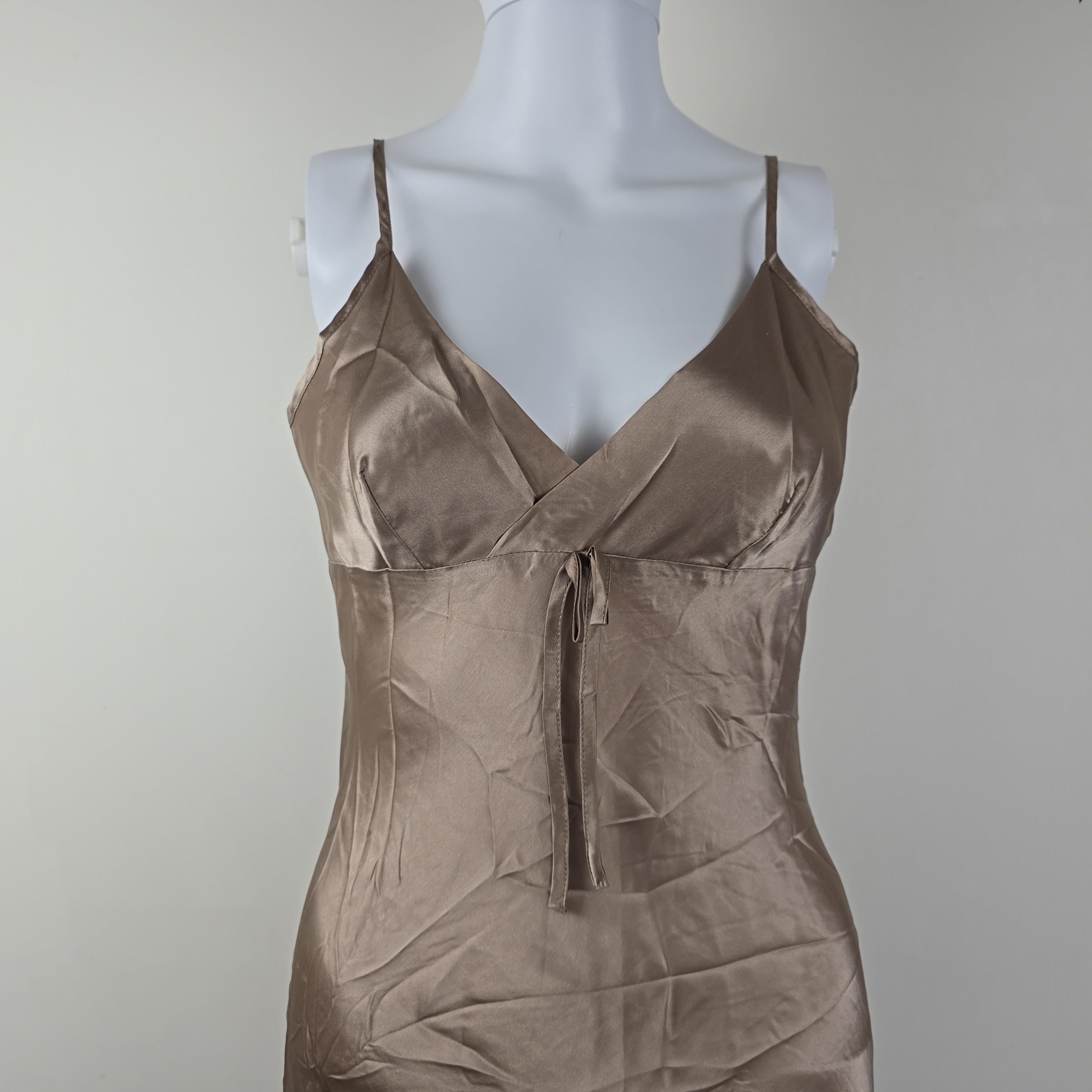 Beige dress on a mannequin against a plain background