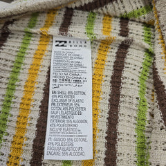 Close-up of a fabric label on a striped garment with visible text.