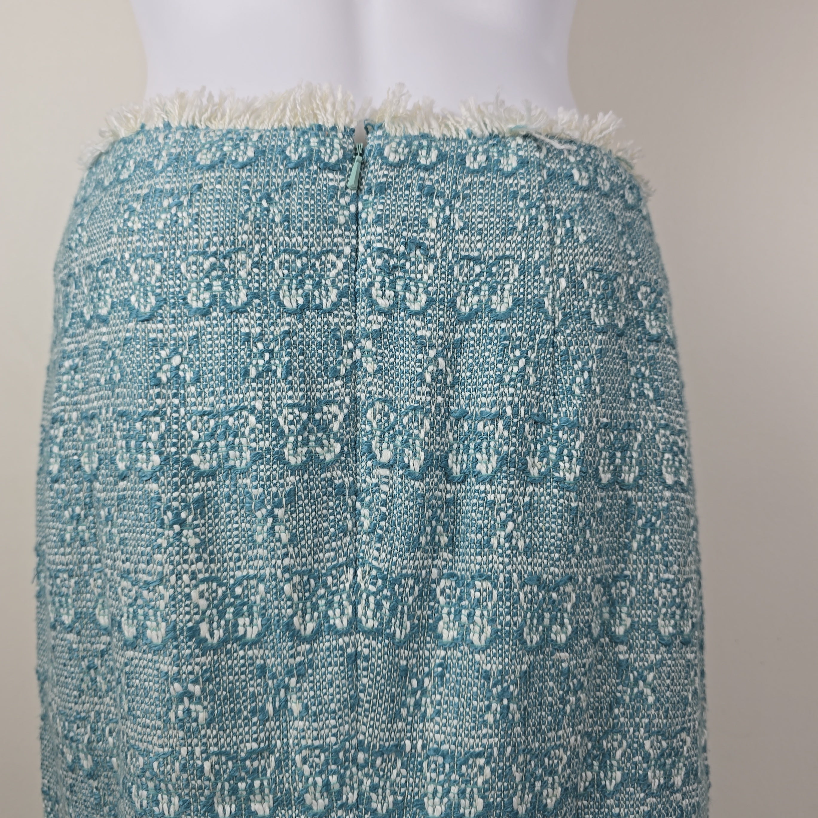 Textured blue fabric skirt with white patterns on a mannequin