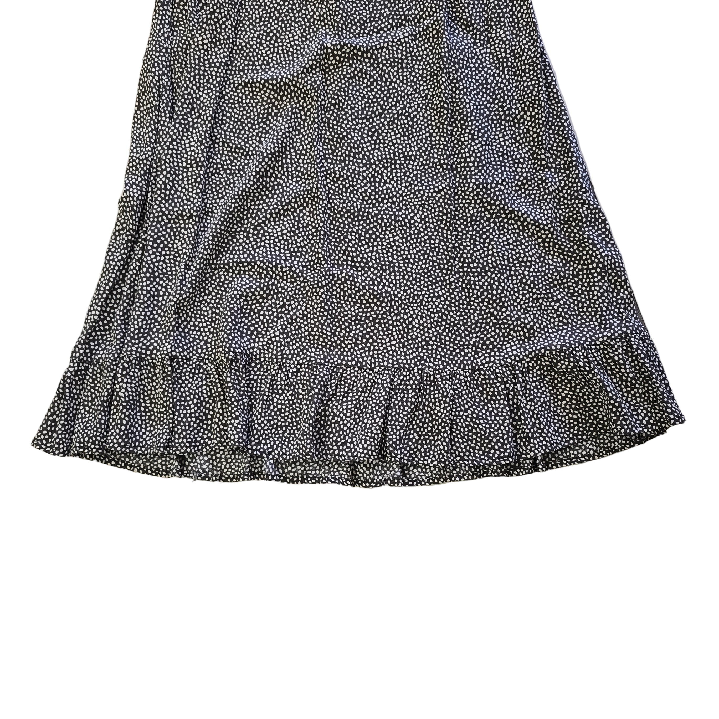 Grey and white spotted patterned dress on a light background