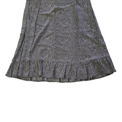 Grey and white spotted patterned dress on a light background