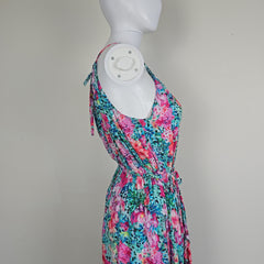 Floral-patterned fabric draped over a mannequin arm on a gray background