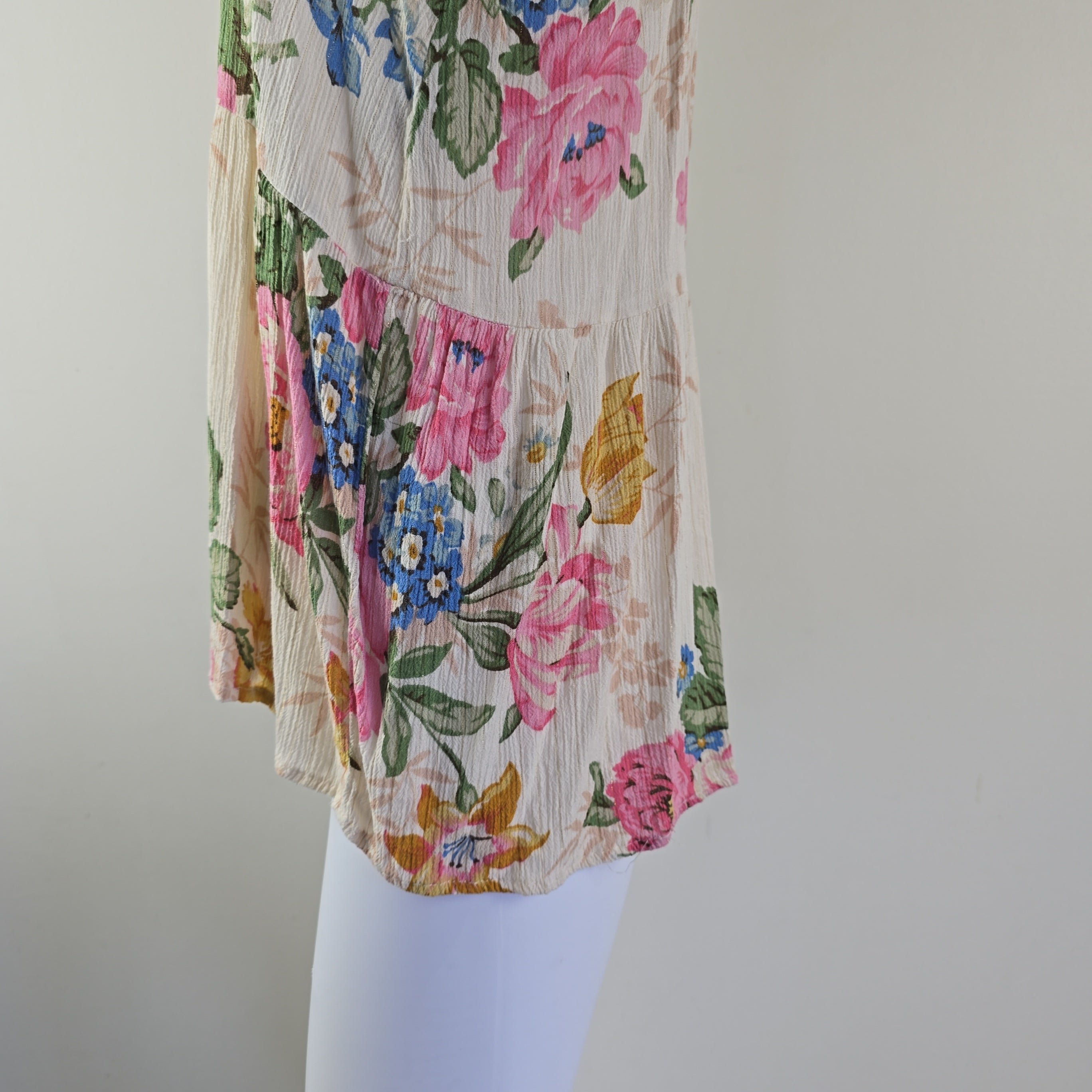 Floral-patterned fabric with pink, blue, and yellow flowers on a plain background