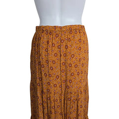 Brown pleated dress with a subtle pattern on a mannequin against a plain background