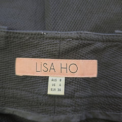 Close-up of a label on a garment with 'Lisa Ho' branding.