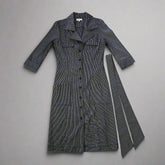 Dark gray dress with buttons on a tiled floor