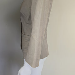 Mannequin wearing beige jacket on a plain background