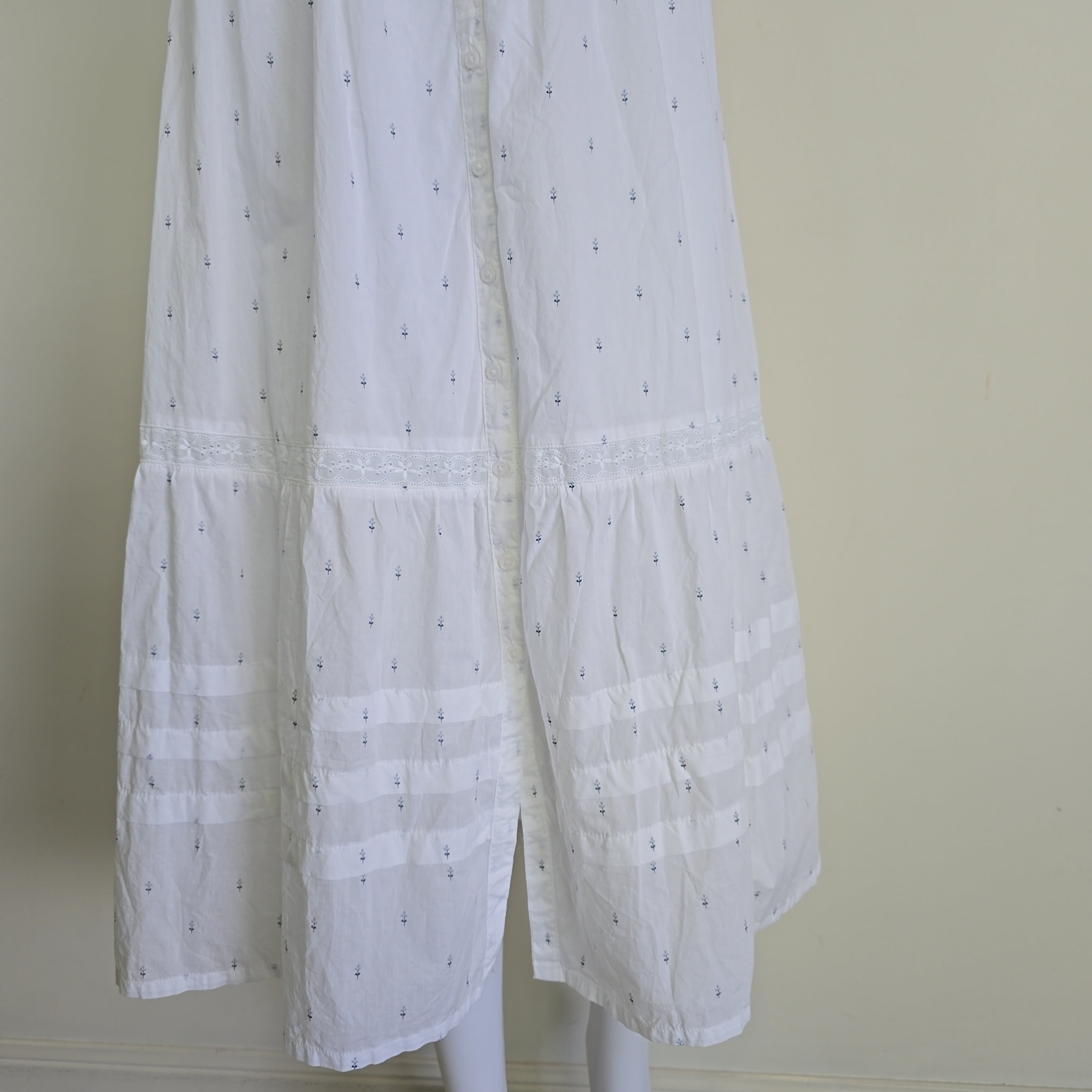 White fabric skirt with a subtle pattern on a white background