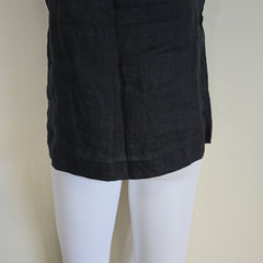 Black fabric draped over a mannequin on a beige background