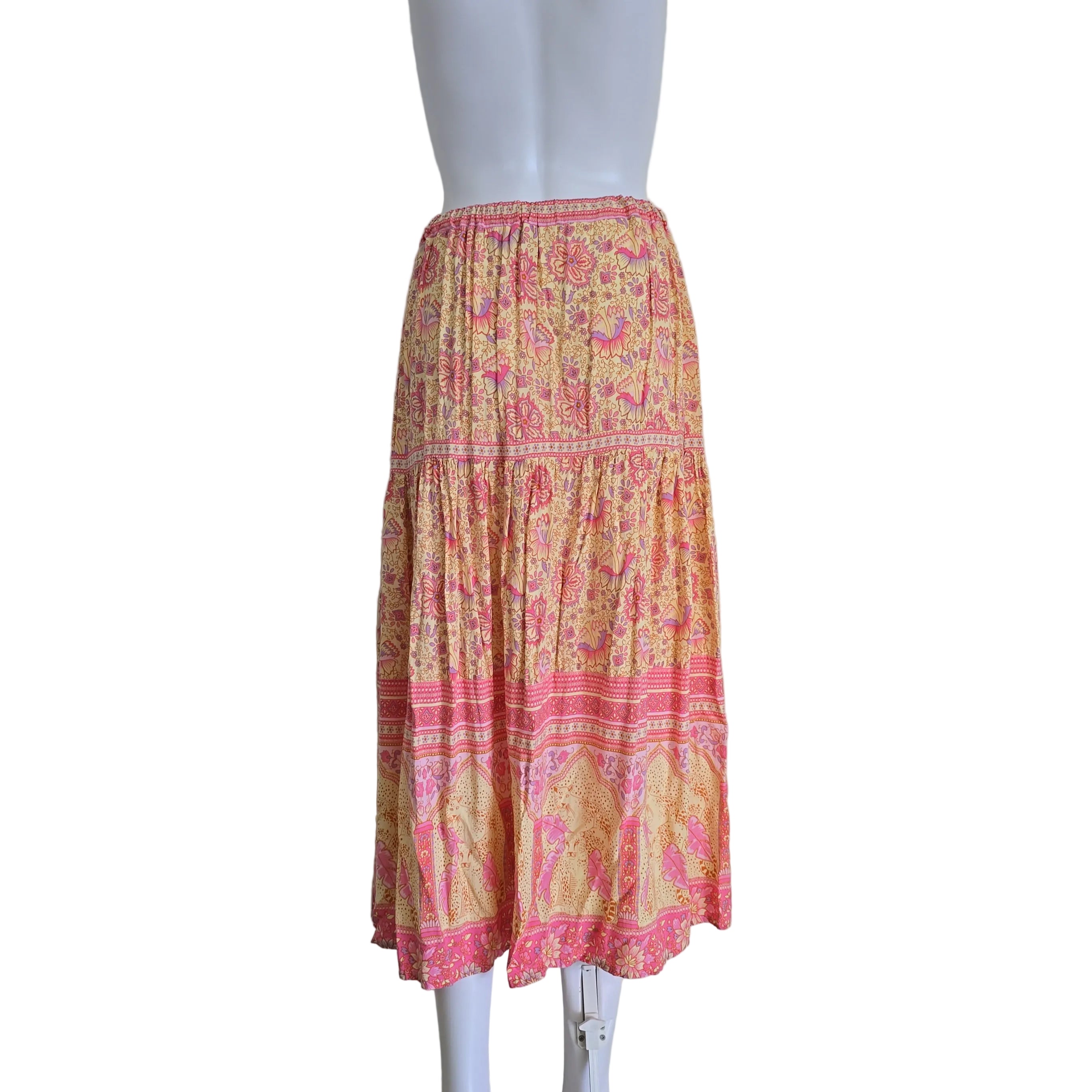Pink and yellow patterned fabric on a mannequin against a white background