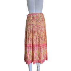 Pink and yellow patterned fabric on a mannequin against a white background