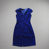 A vintage cobalt blue fitted dress with a V-neckline, cap sleeves, and a concealed back zipper.