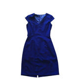 A vintage cobalt blue fitted dress with a V-neckline, cap sleeves, and a concealed back zipper.