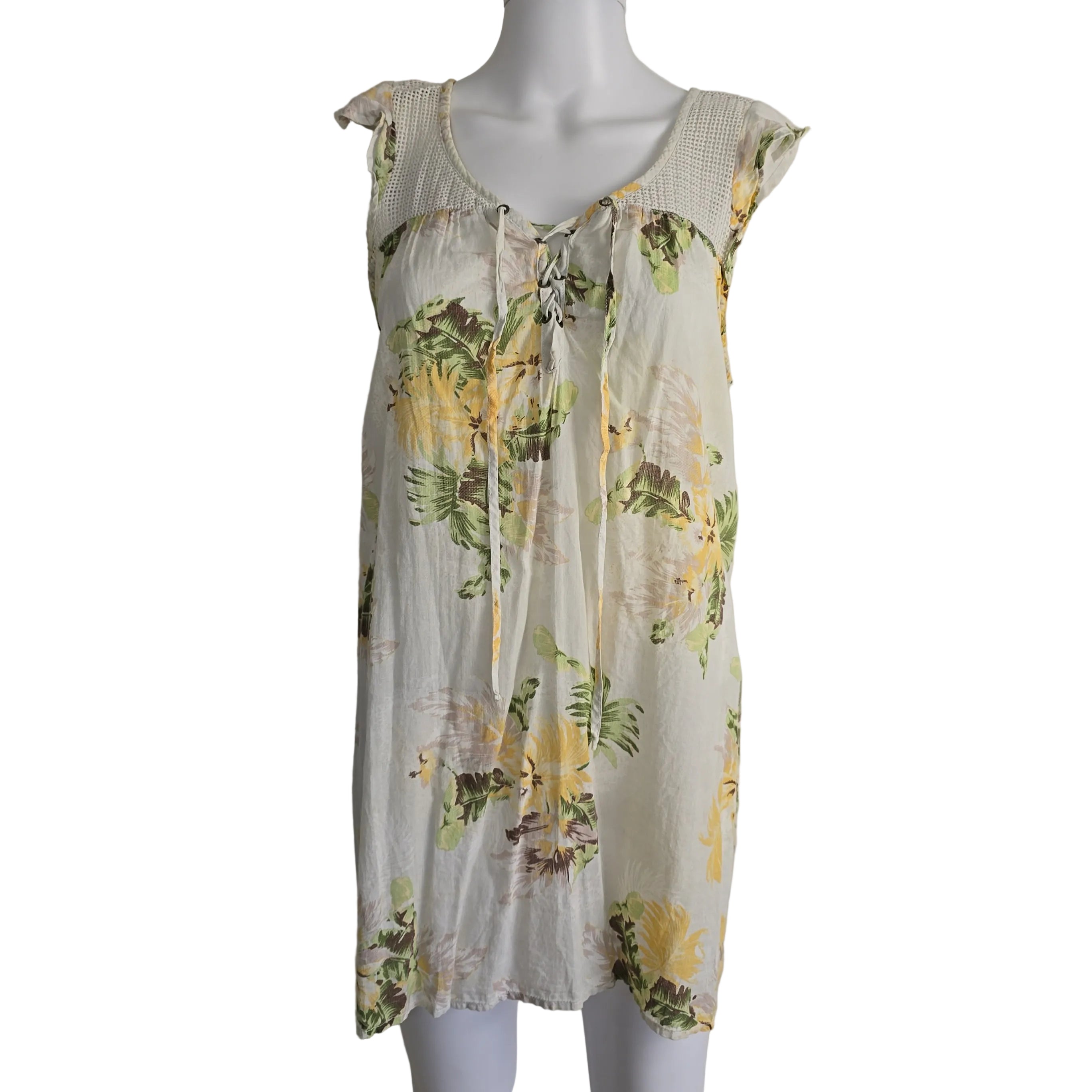 Floral dress on a mannequin against a plain background
