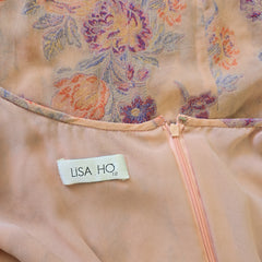 Close-up of a floral garment with a Lisa Ho label.
