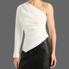 Woman wearing a one-shoulder white top and black skirt on a white background