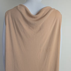 Mannequin wearing a beige top on a plain background