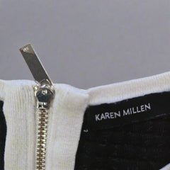Close-up of a zipper on a garment with 'Karen Millen' branding.