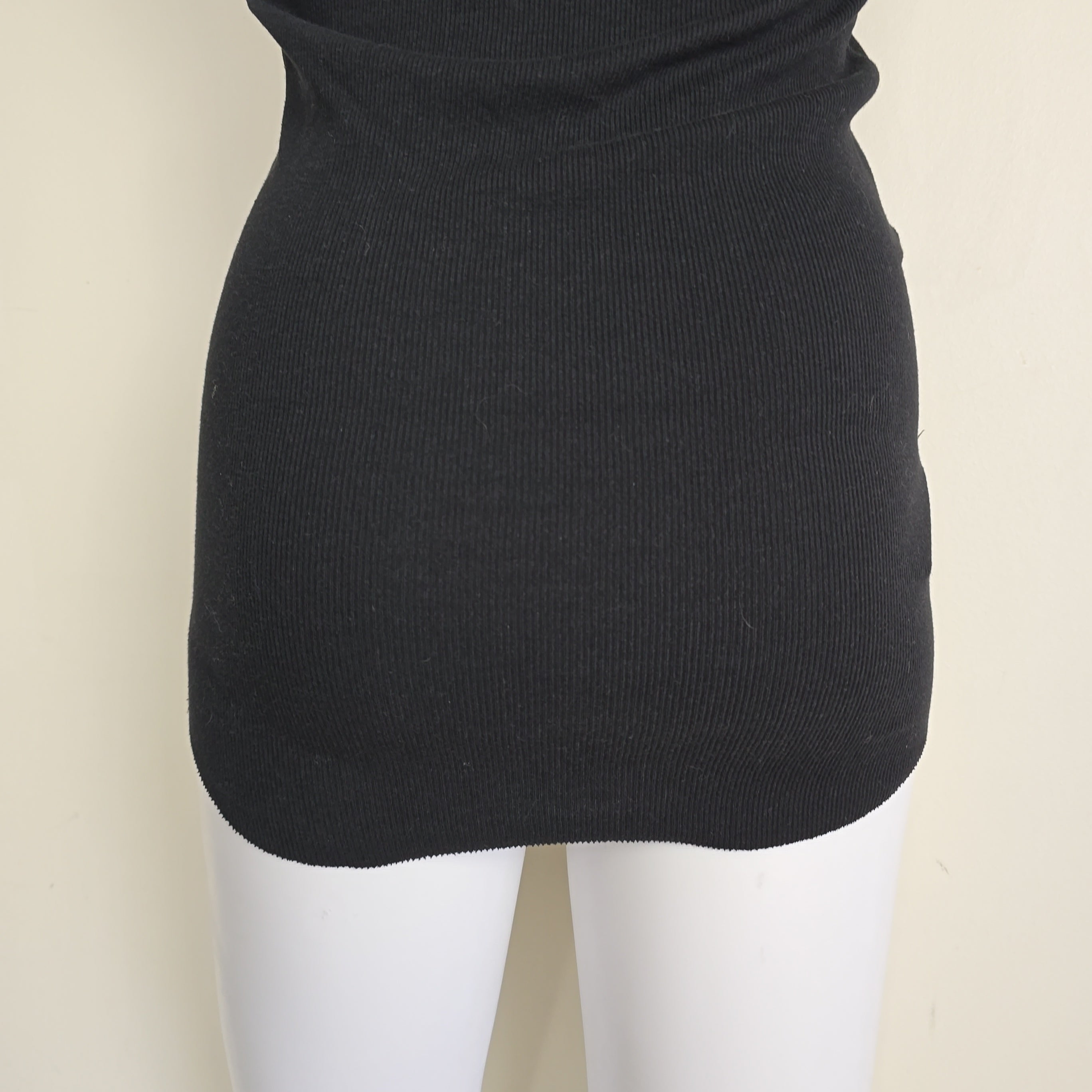 Black sleeveless top on a light background