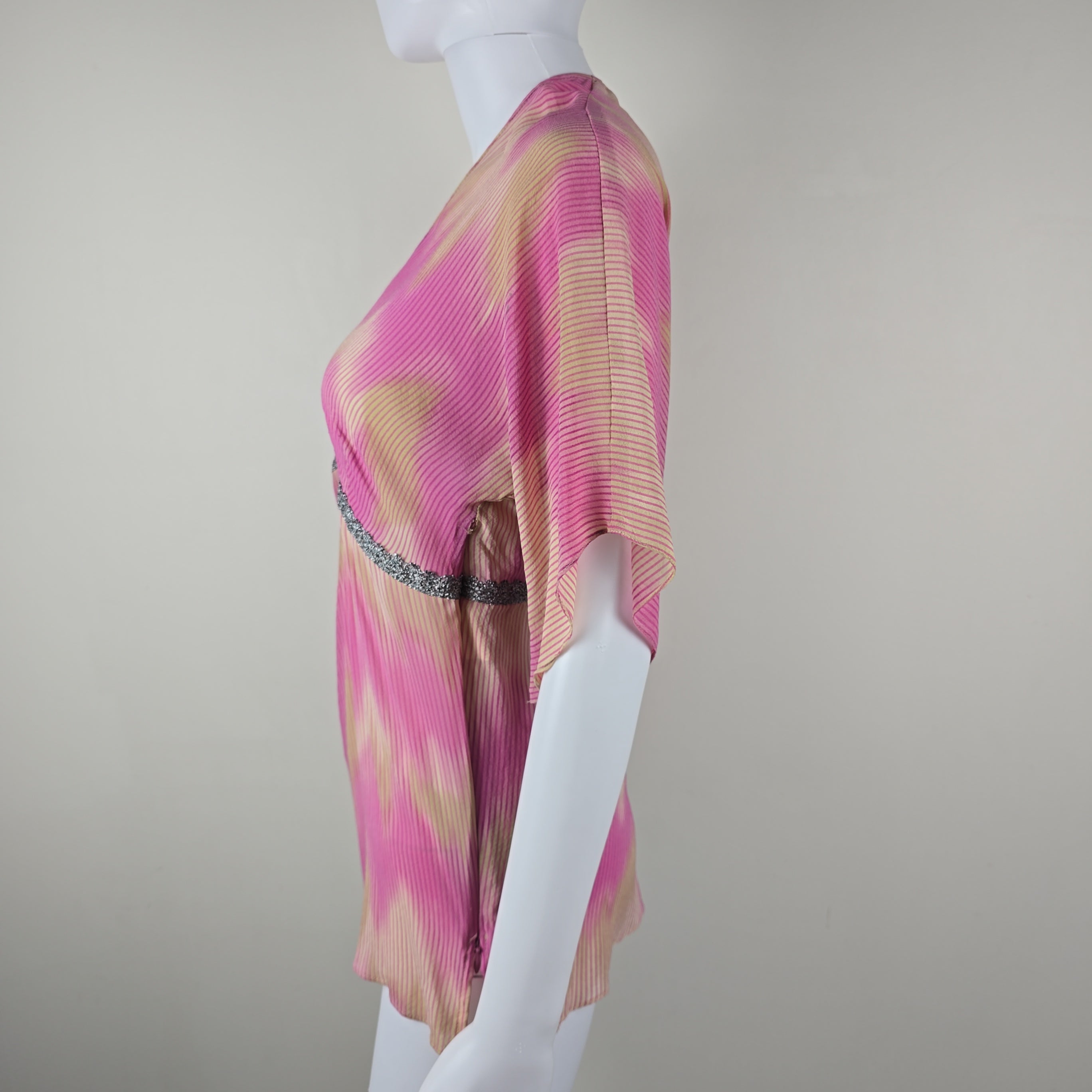 Pink and beige patterned fabric on a light gray background