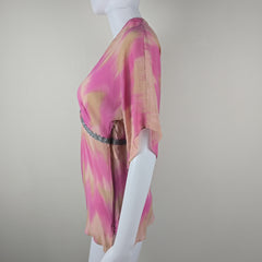 Pink and beige patterned fabric on a light gray background