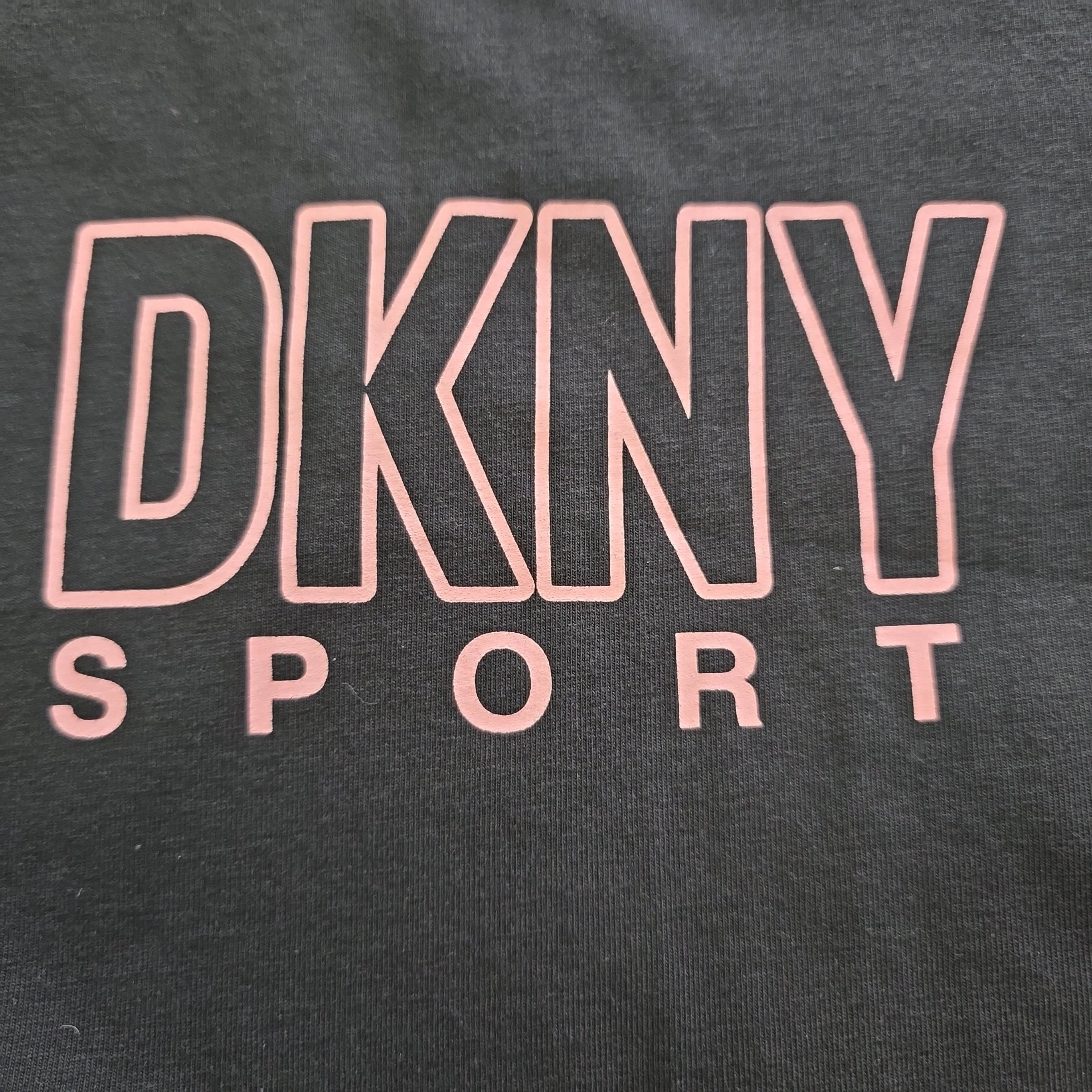 DKNY Sport logo on a dark background