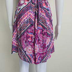 Pink and purple patterned fabric on a mannequin against a plain background