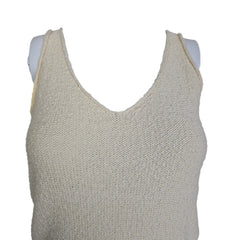 Mannequin wearing a beige textured top against a plain background