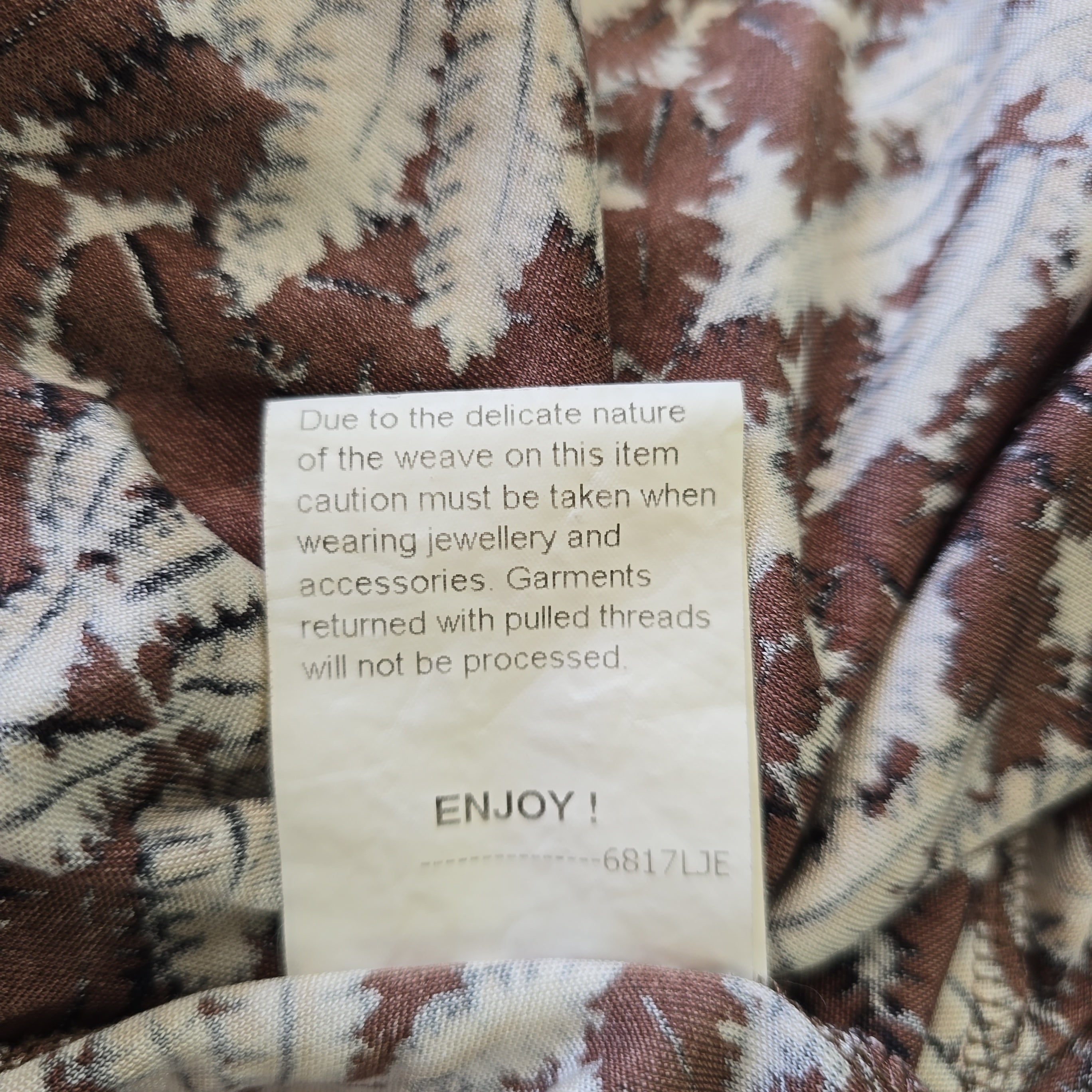 Textile with a patterned fabric and a care label on it.