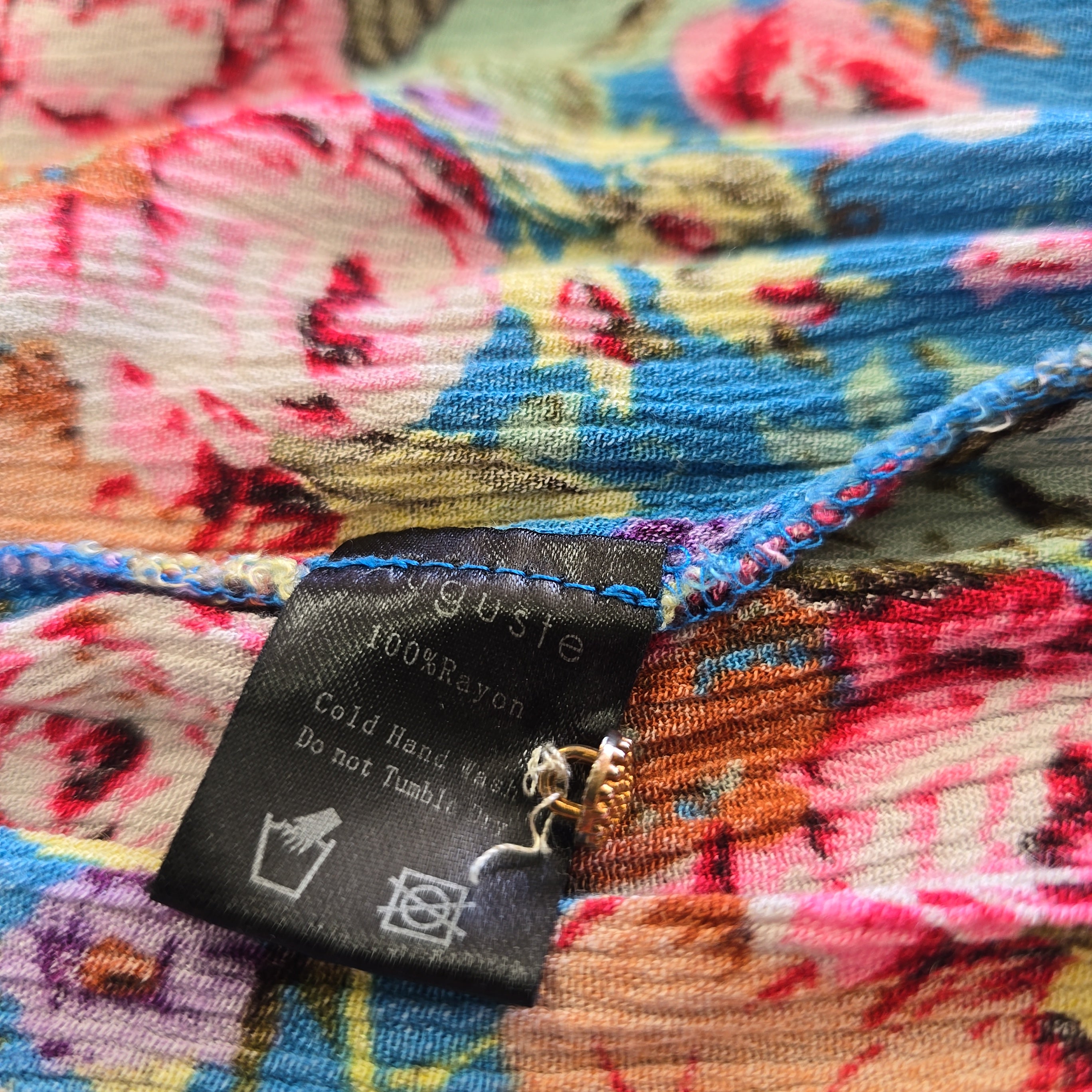 Close-up of a colorful fabric with a label on a floral patterned background