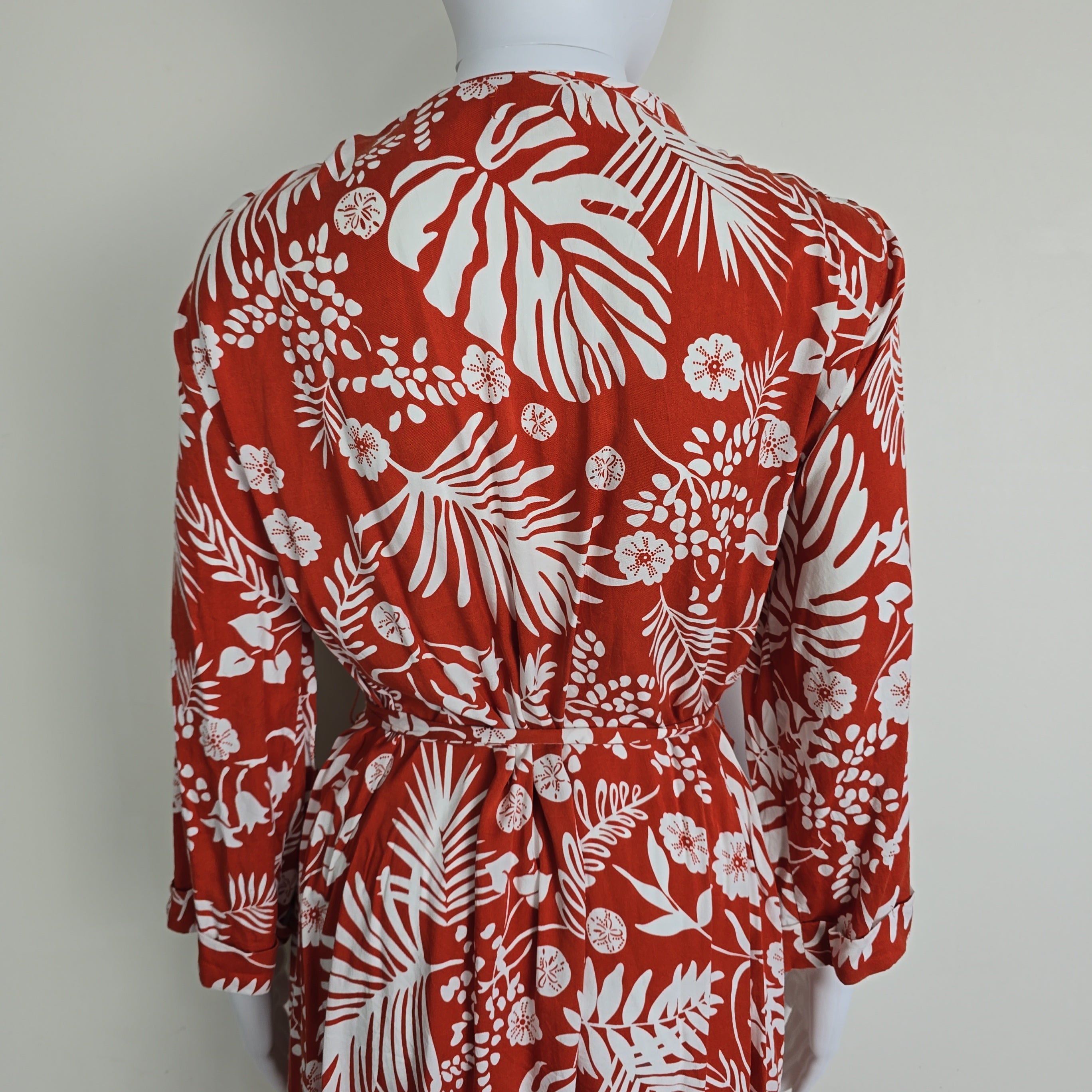 Red fabric with white floral pattern on a white background